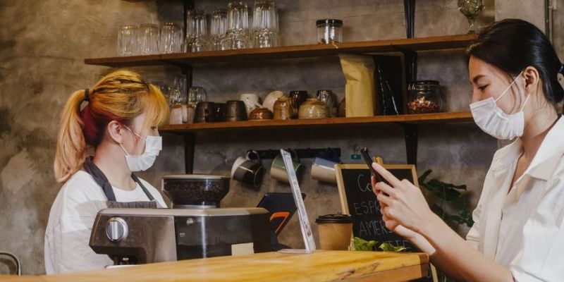 Cashier taking orders from a customer