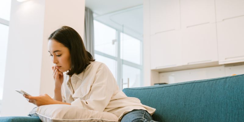 A woman scrolling through social media on her phone
