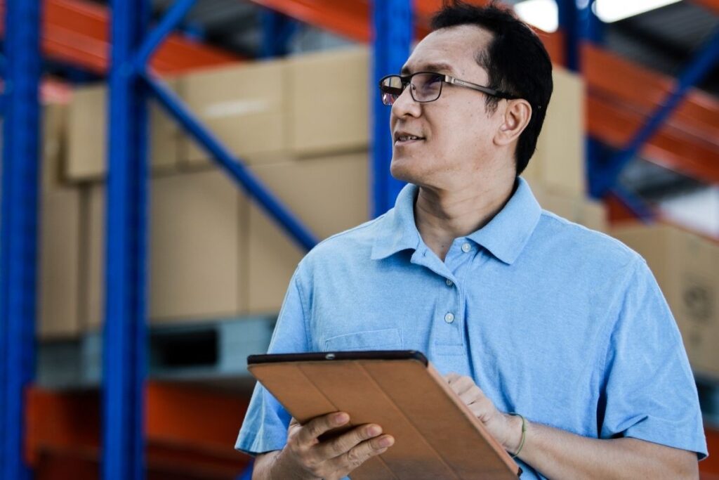 Malaysian business owner checking inventory at warehouse