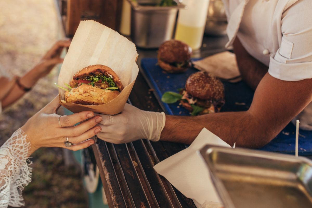 A quick-service restaurant staff serving a customer.