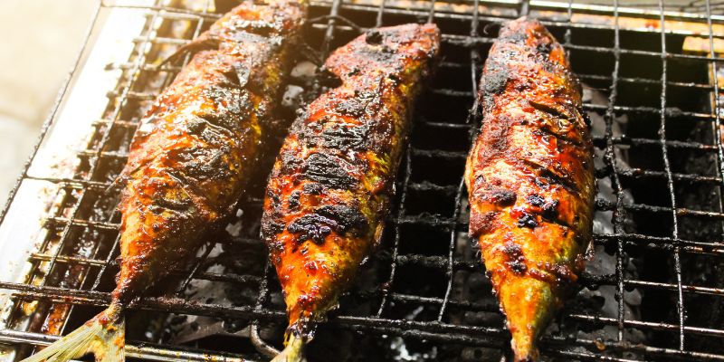 Ikan bakar being grilled