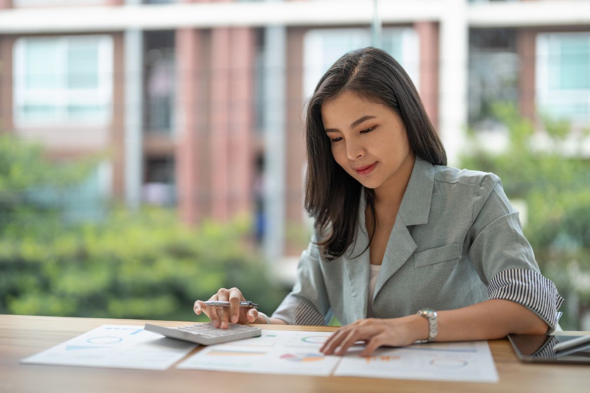 A Malaysian business owner working on her business' budget