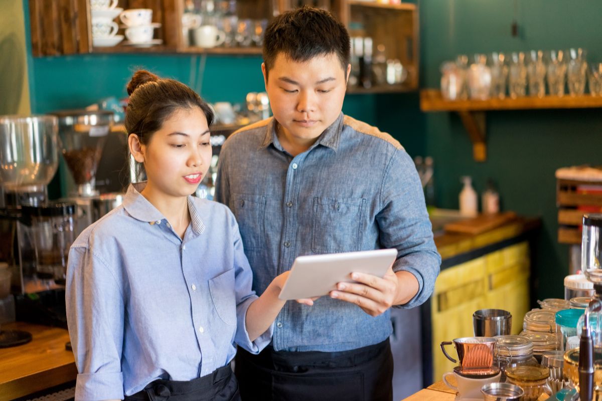 A Malaysian couple working together in their restaurant