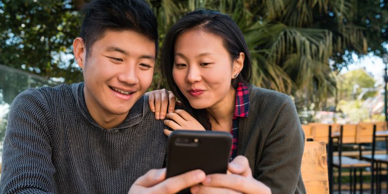 A Malaysian couple looking at a phone