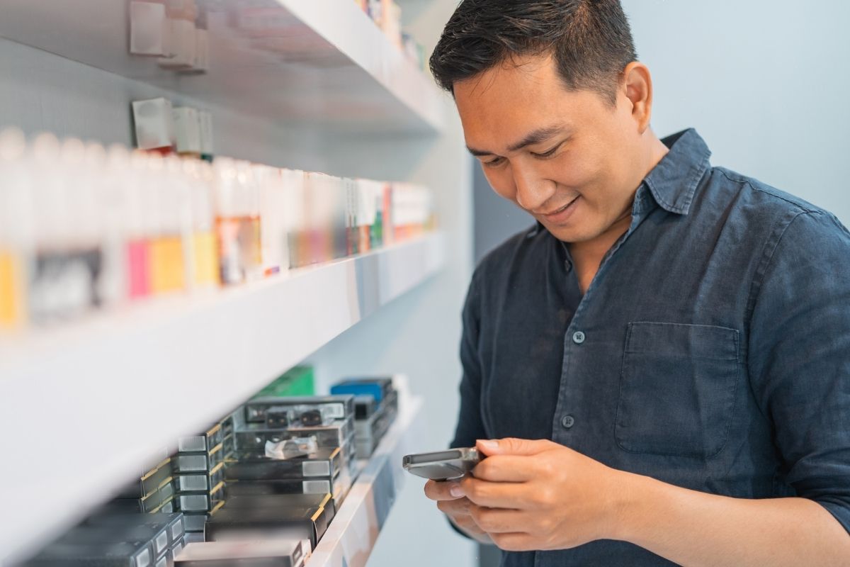 A Malaysian vape shop owner on his phone