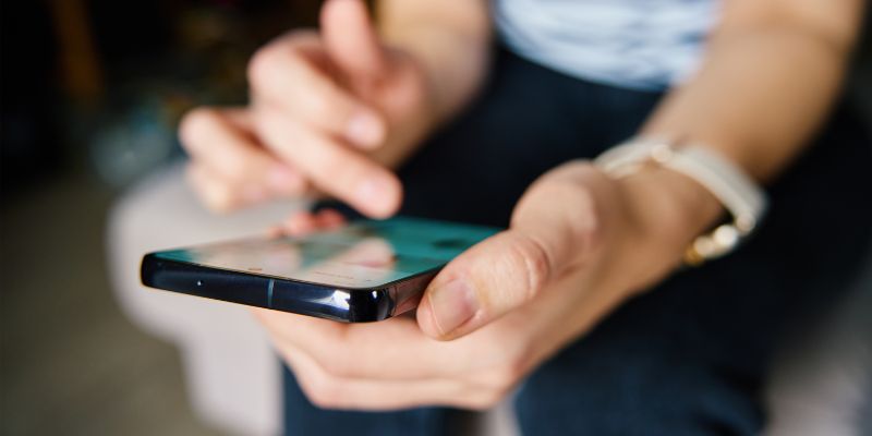 A Malaysian woman scrolling through her phone